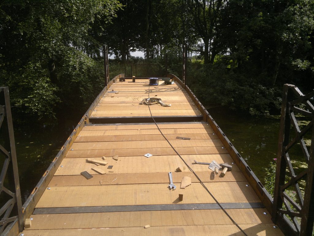 New sawn Iroko timber deck being installed on the restored cast-iron bridge